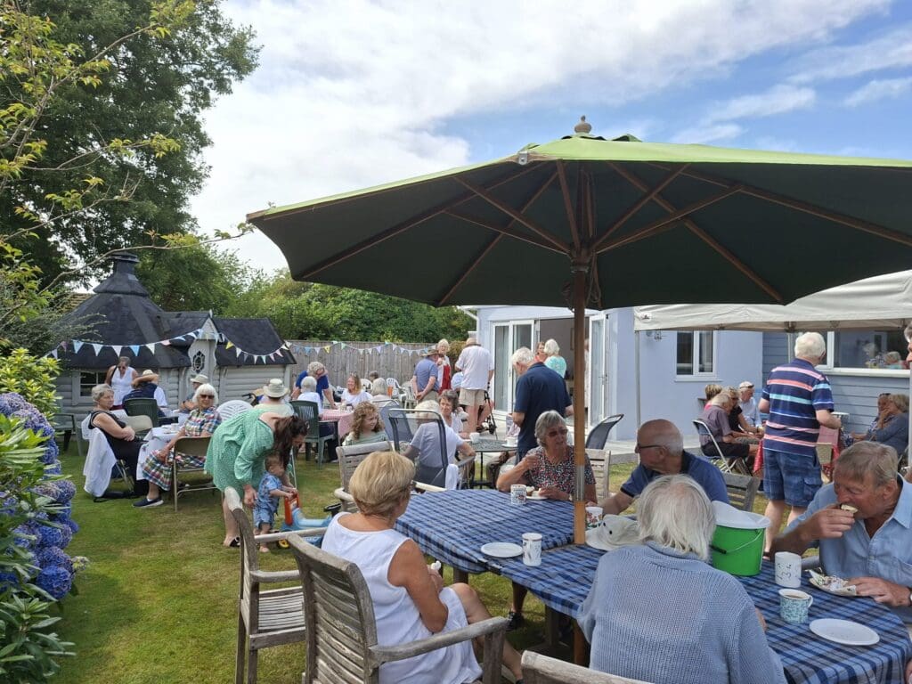 People enjoying a cream tea outside
