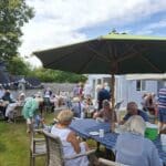 People enjoying a cream tea outside